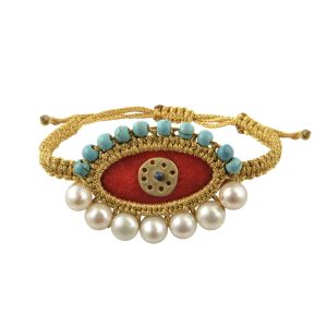 Folklore-inspired red velvet evil eye bracelet, embroidered with gold thread and adorned with turquoise beads, pearls and a handmade brass circle on macramé cord.